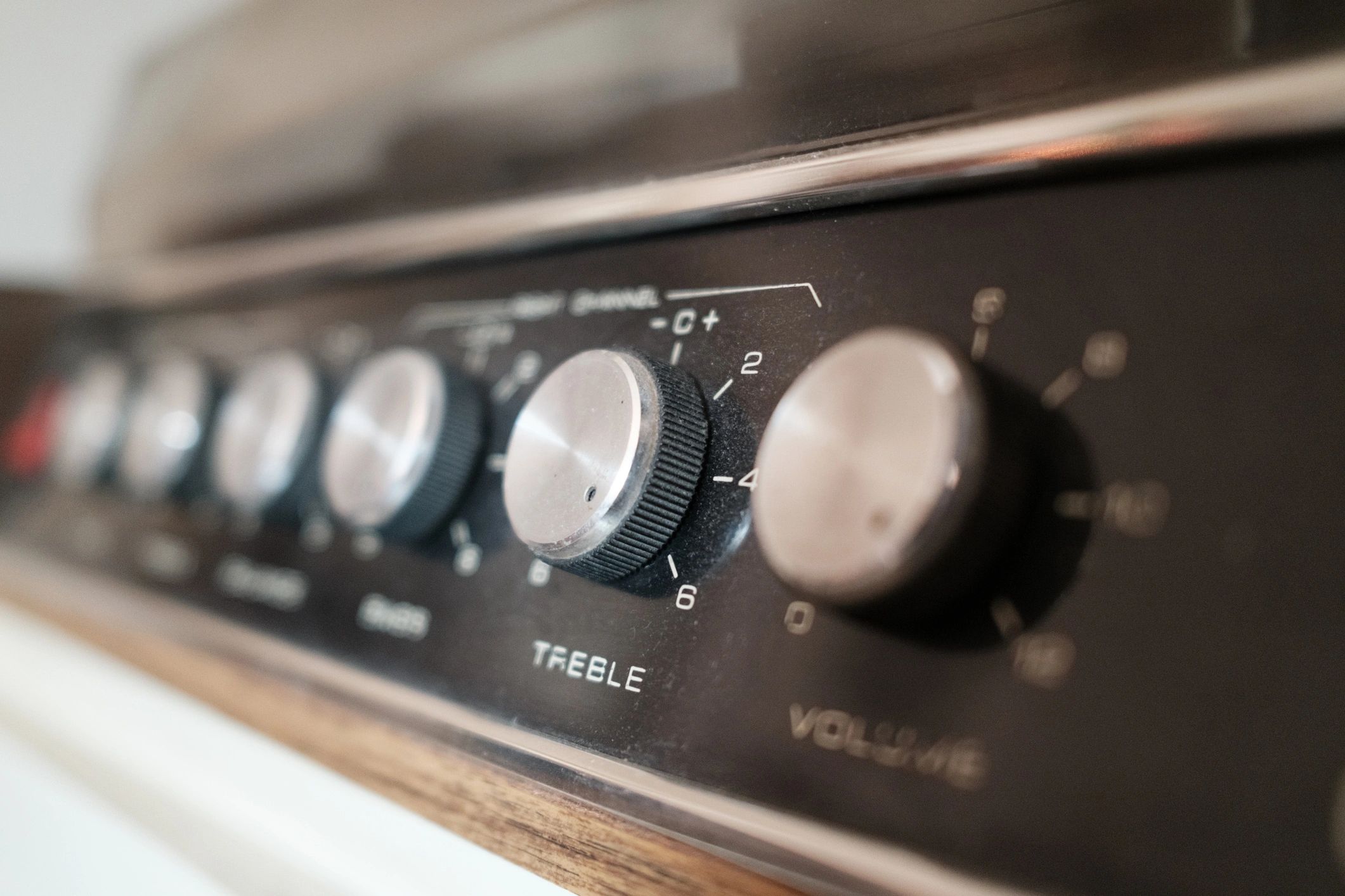 Vintage stereo control panel showing treble and volume knobs