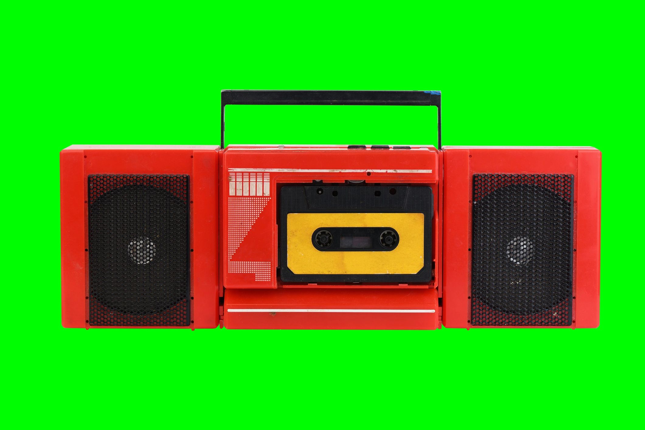 Vintage cassette tape recorder on green background